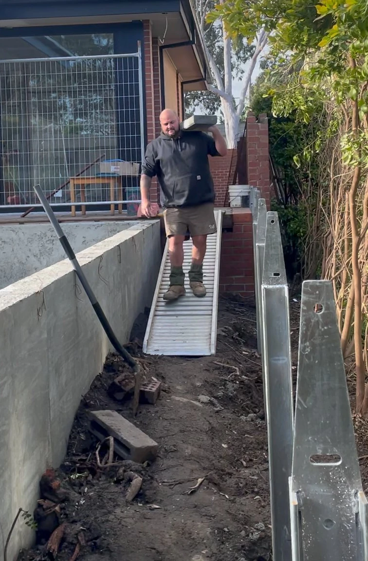 Trav on site carrying a sleeper